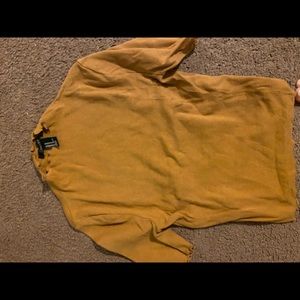 a mustard yellow ribbed fitted top